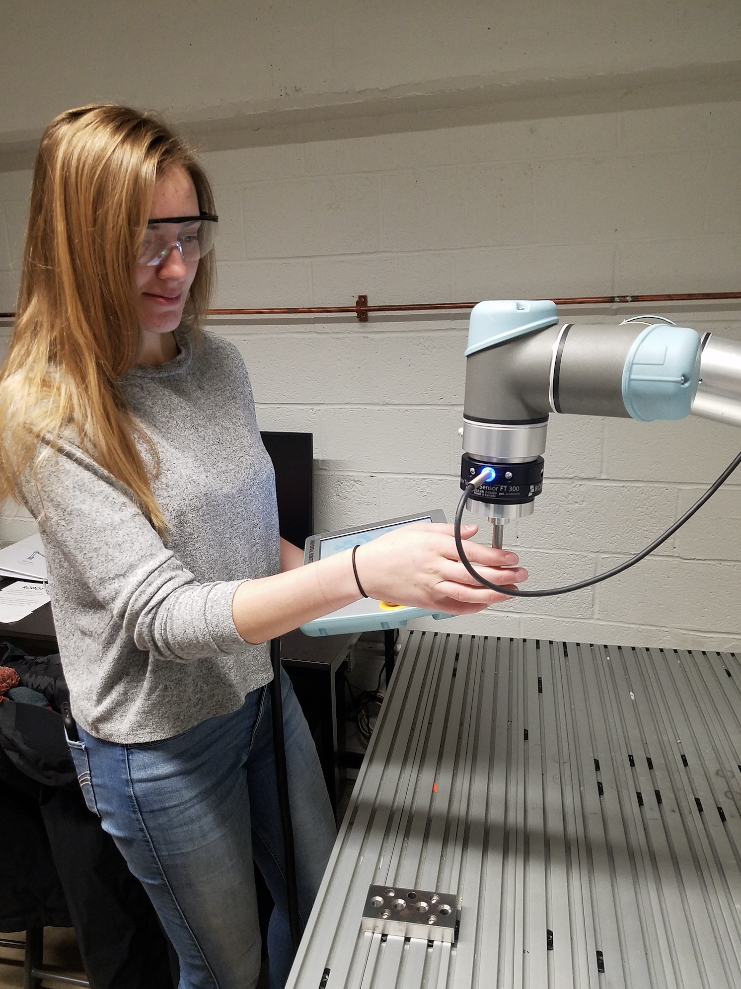 Student works with robotic arm